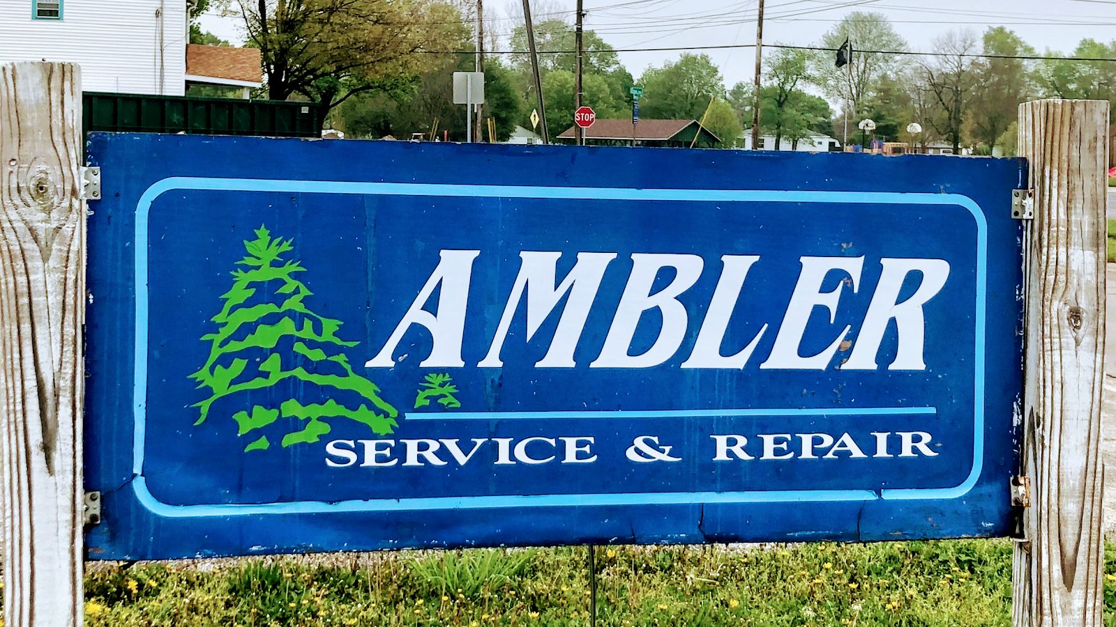 Hand-painted Ambler Service & Repair sign with a green pine tree on Grant Street in Huntington, Indiana